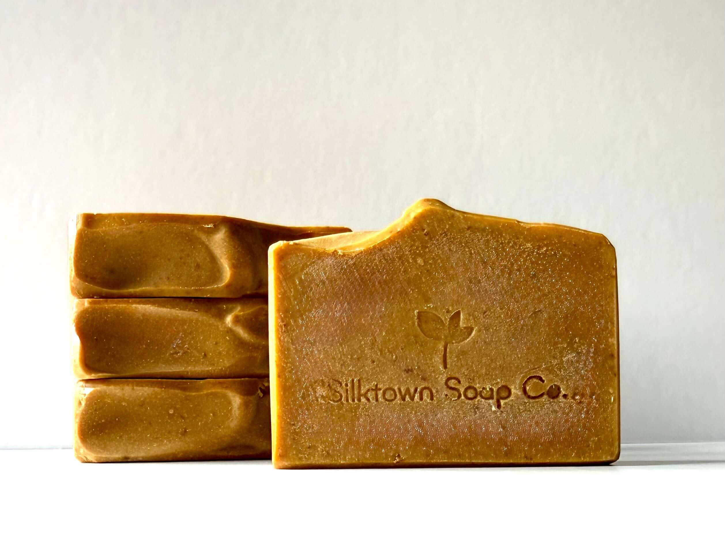 Four bars of natural soap from Silktown Soap Co. on a white background