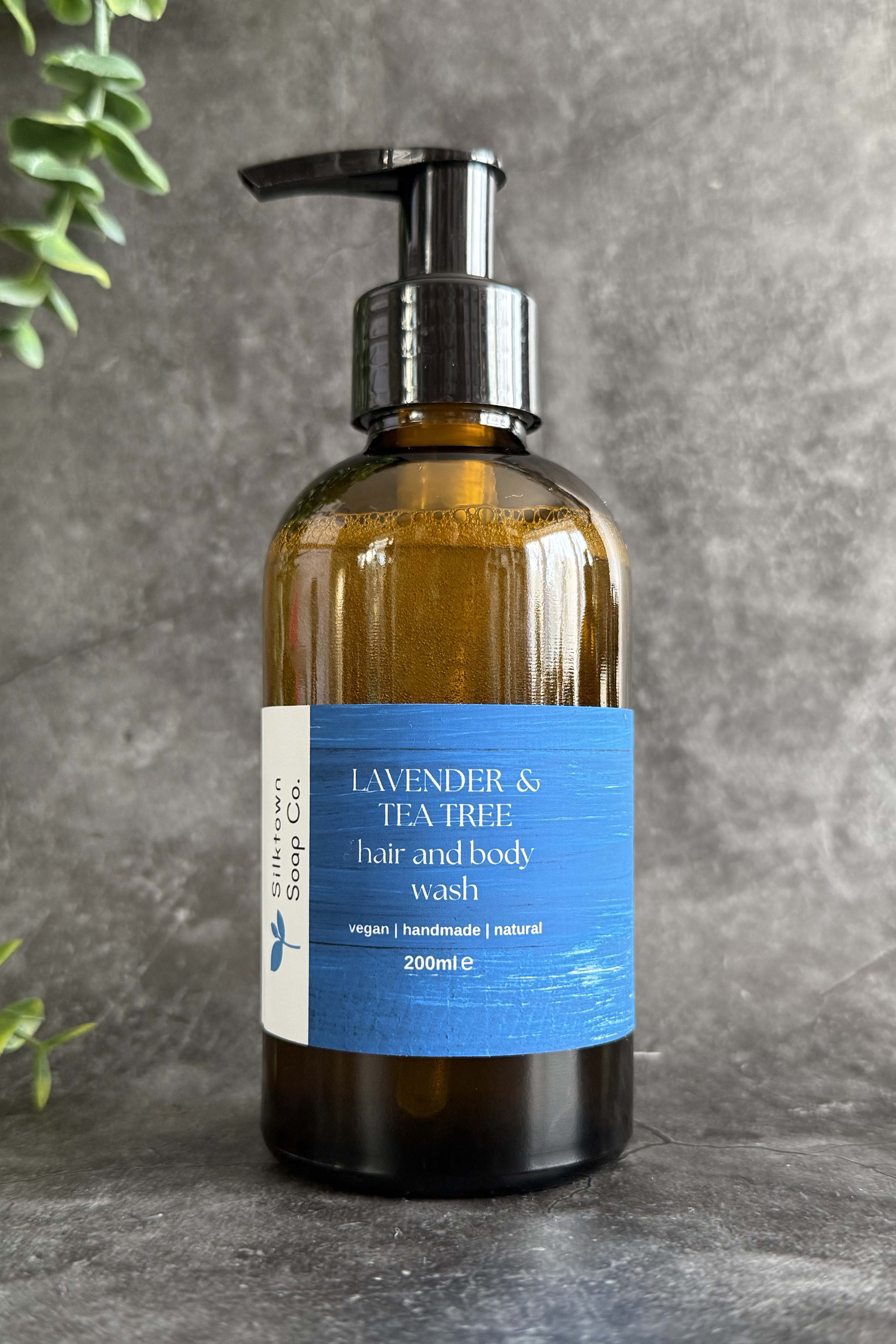 A pump bottle of natural hair and body wash with a label that reads &