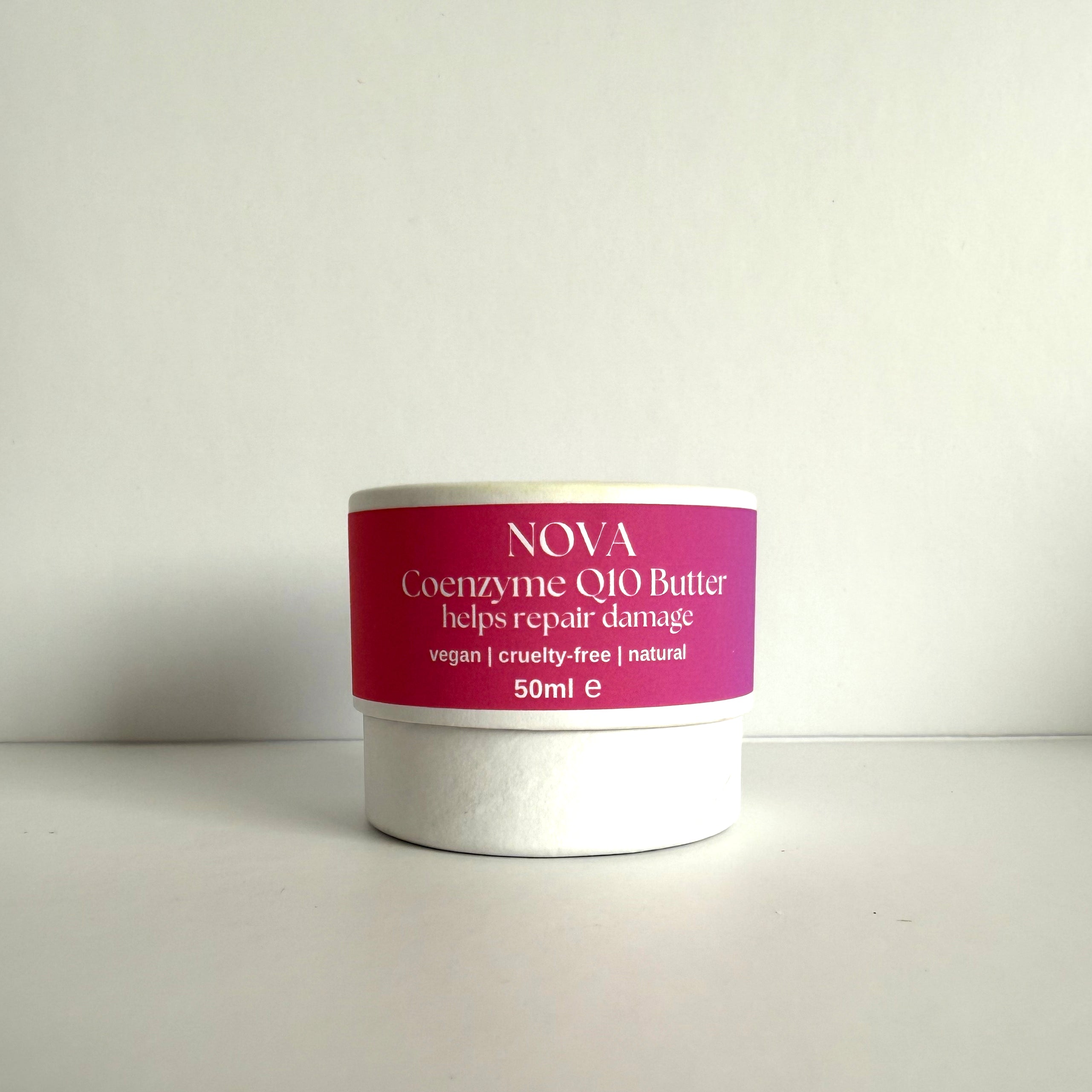 Jar of NOVA Coenzyme Q10 Butter with a pink label on a white background