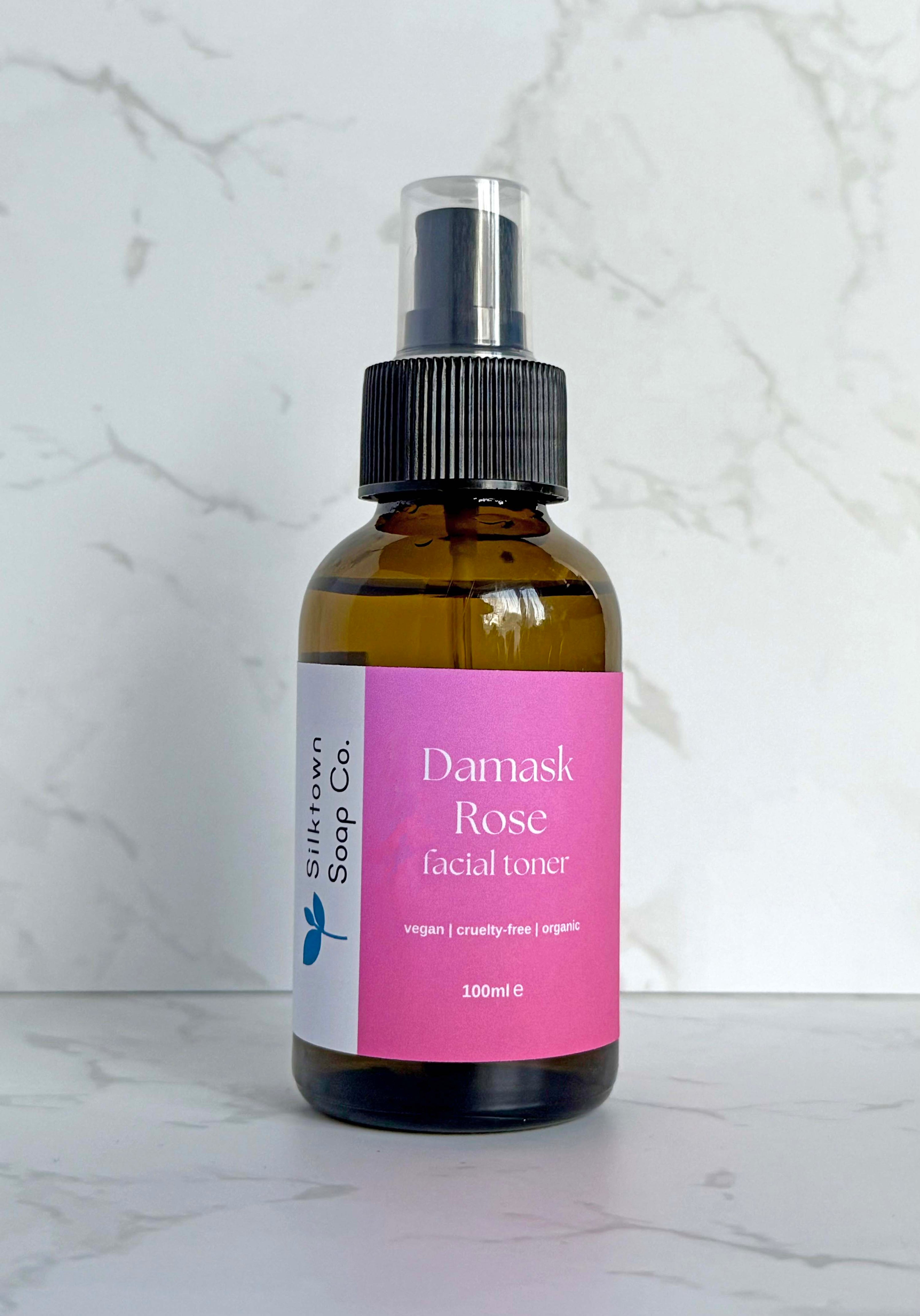 bottle of Natural Facial Toner with Bulgarian Damask Rose with a marble background