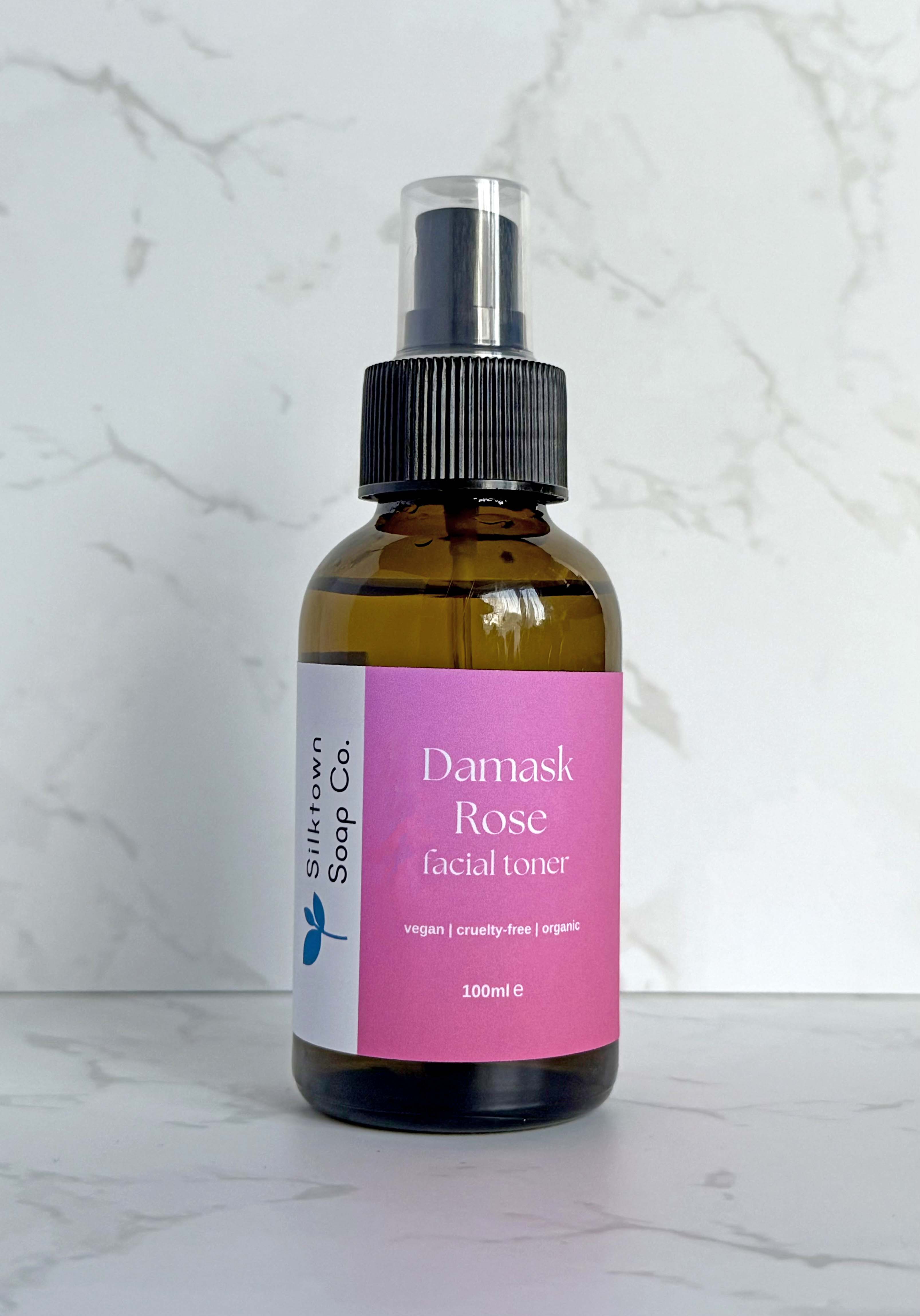 bottle of Natural Facial Toner with Bulgarian Damask Rose with a marble background