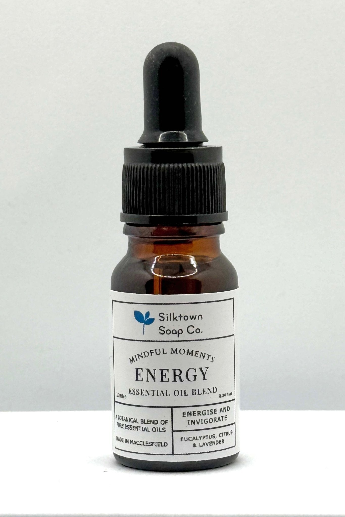 A small dark glass bottle with a dropper, labeled &