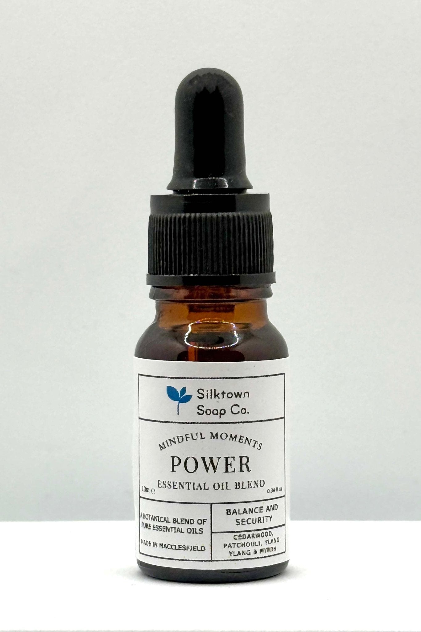 A small amber glass bottle with a dropper, labeled &