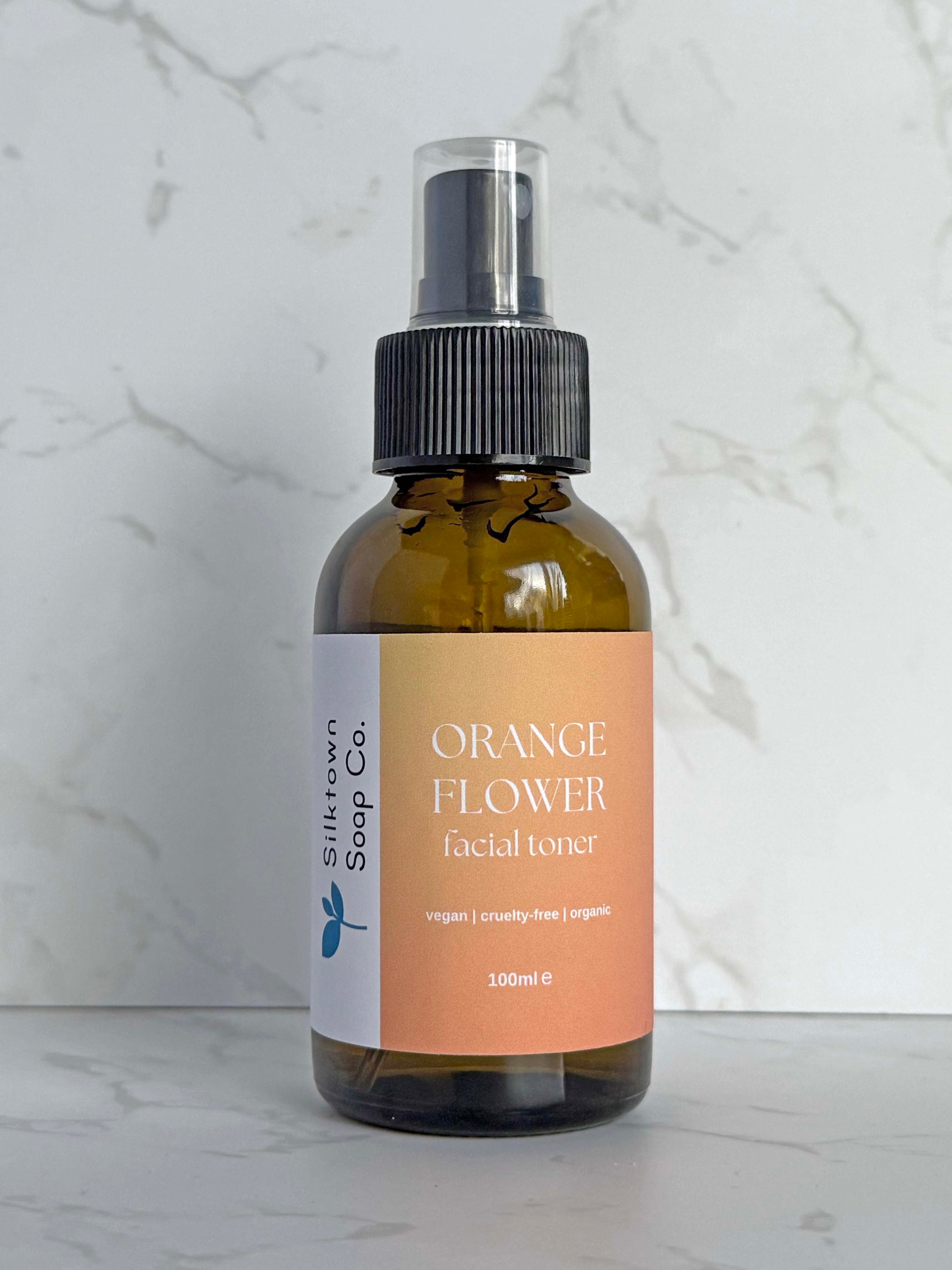 bottle of Natural Facial Toner with Orange, Palmarosa and Neroli with marble background