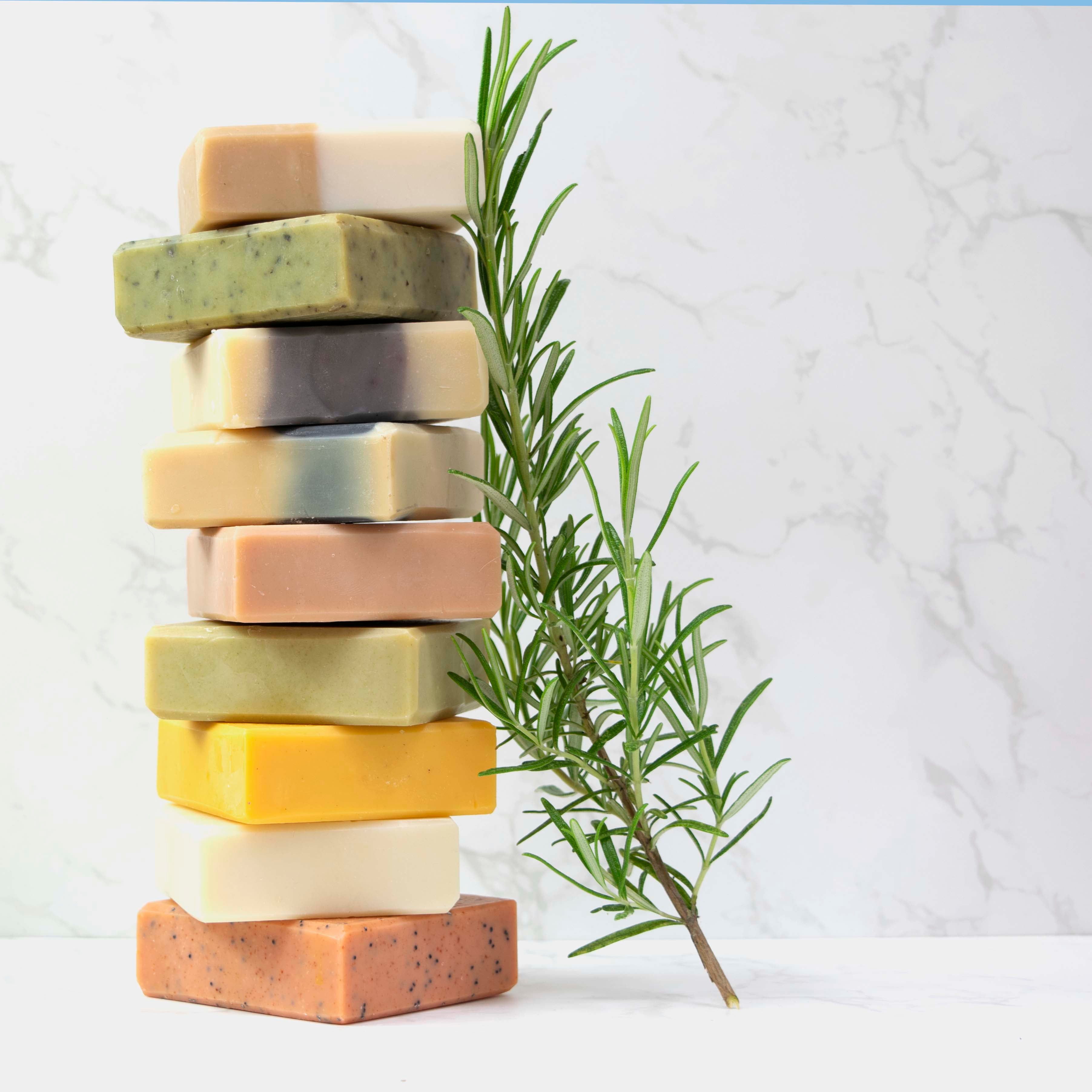 Selection of handmade natural soaps from Silktown Soap Company in a stack with rosemary sprig