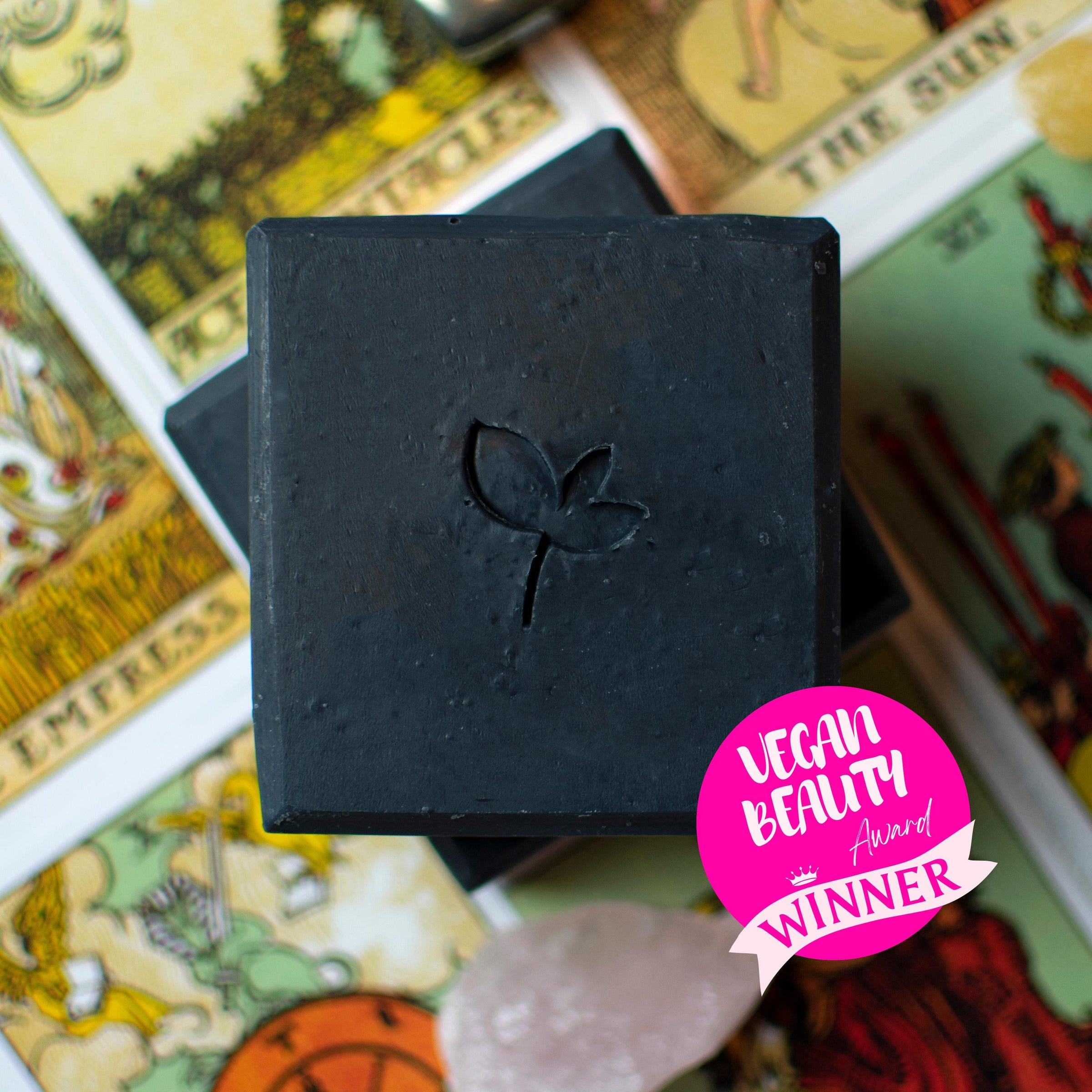 Award-winning natural soa bar with charcoal on top of tarot cards with award