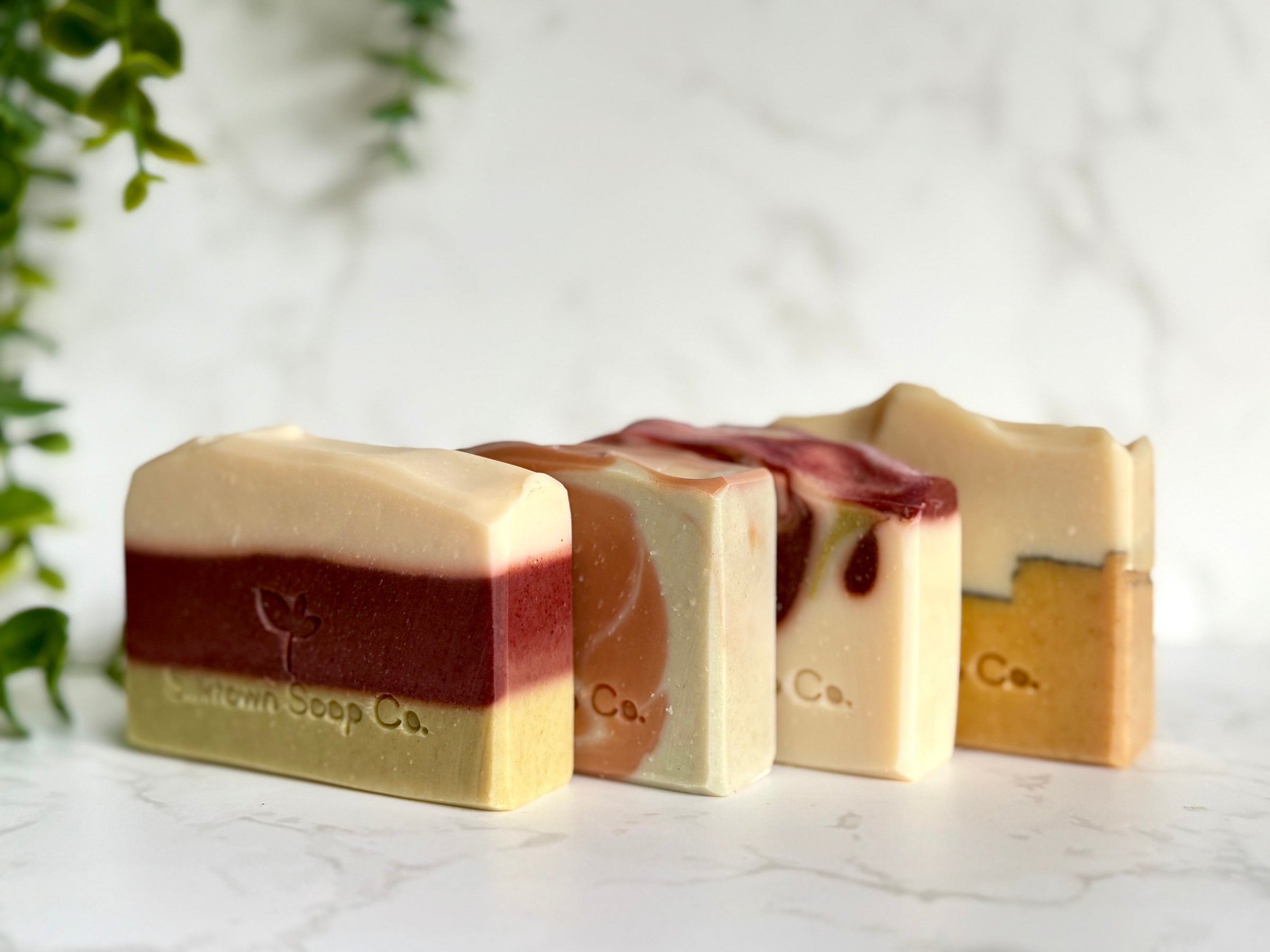 The Macclesfield Collection of natural soap collection on marble surface with foliage