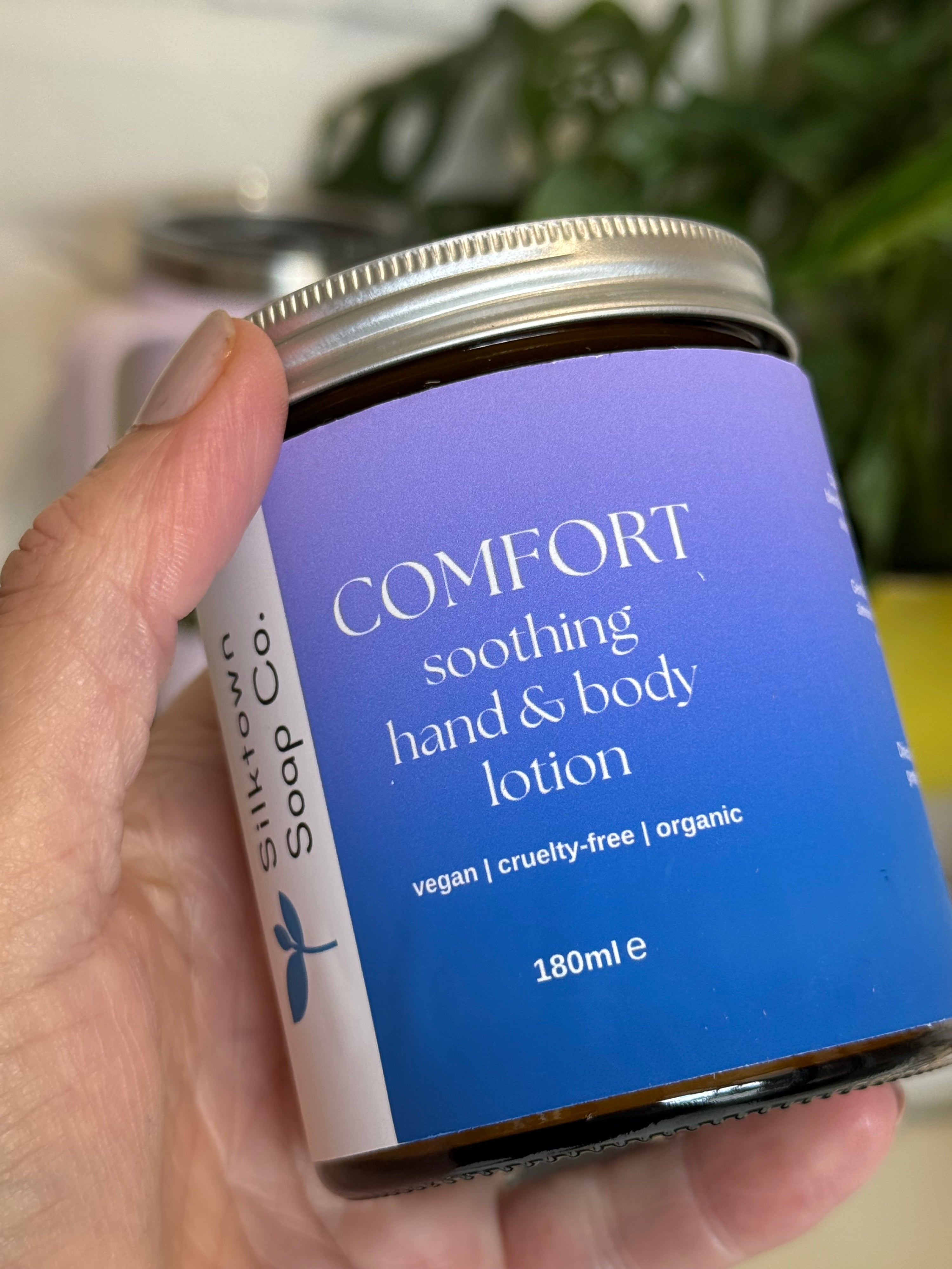 Hand holding a jar of &