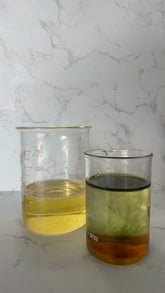 Two containers of oils featured in Dreamweaver Botanical Skincare Oil by Silktown Soap Co., highlighting the nourishing ingredients of this soothing product.