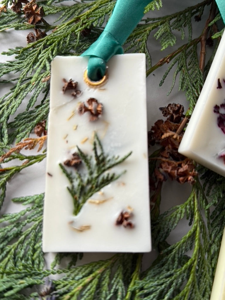 Natural Wax Freshener - Woodland with a green ribbon on some green woodland foliage