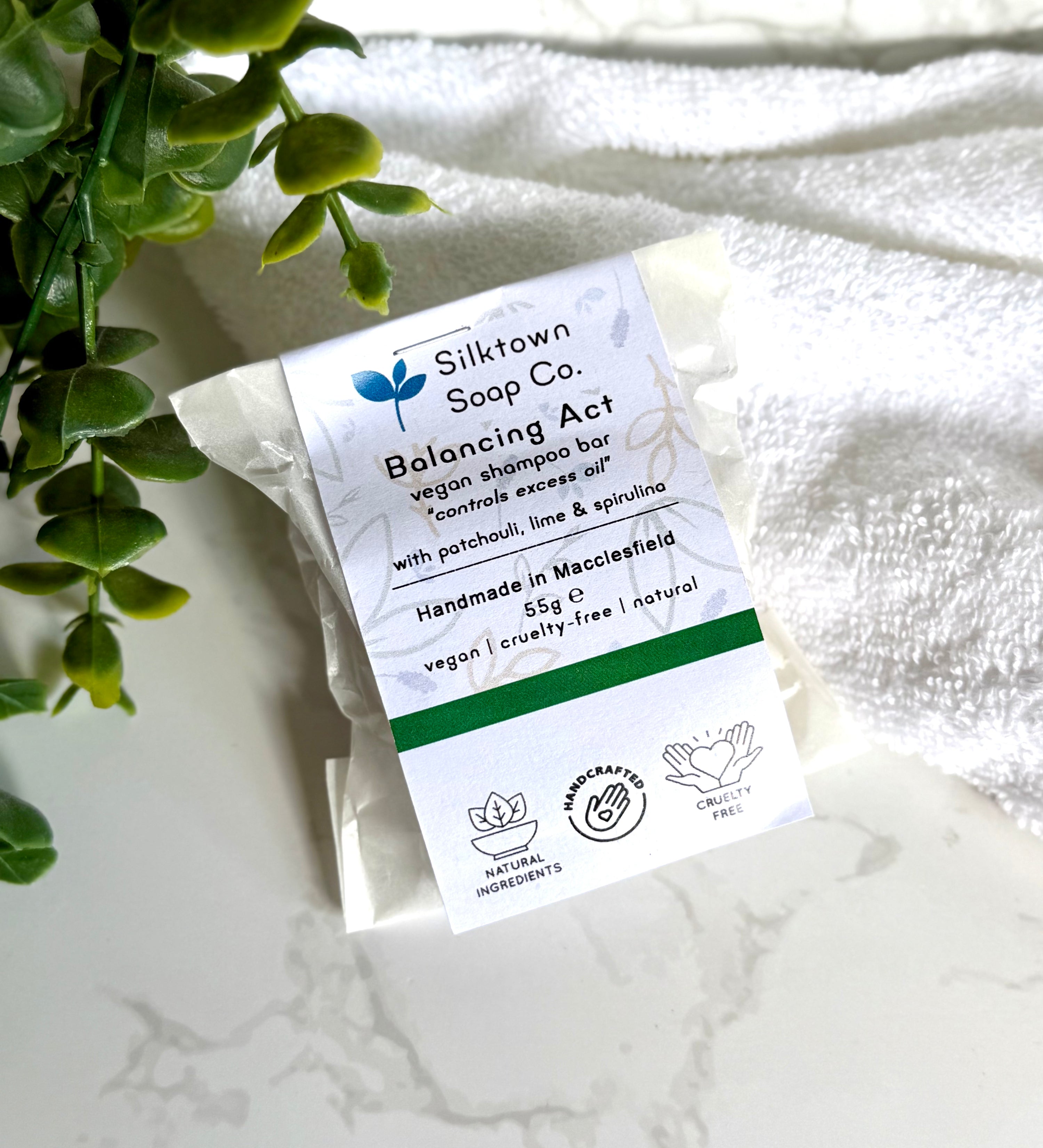 Silktown Soap Co. Natural Shampoo Bar - Balancing Actwith label on a white marble surface with greenery.