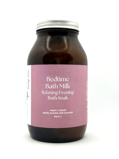 Bottle of Bedtime Bath Milk with a pink label on a white background