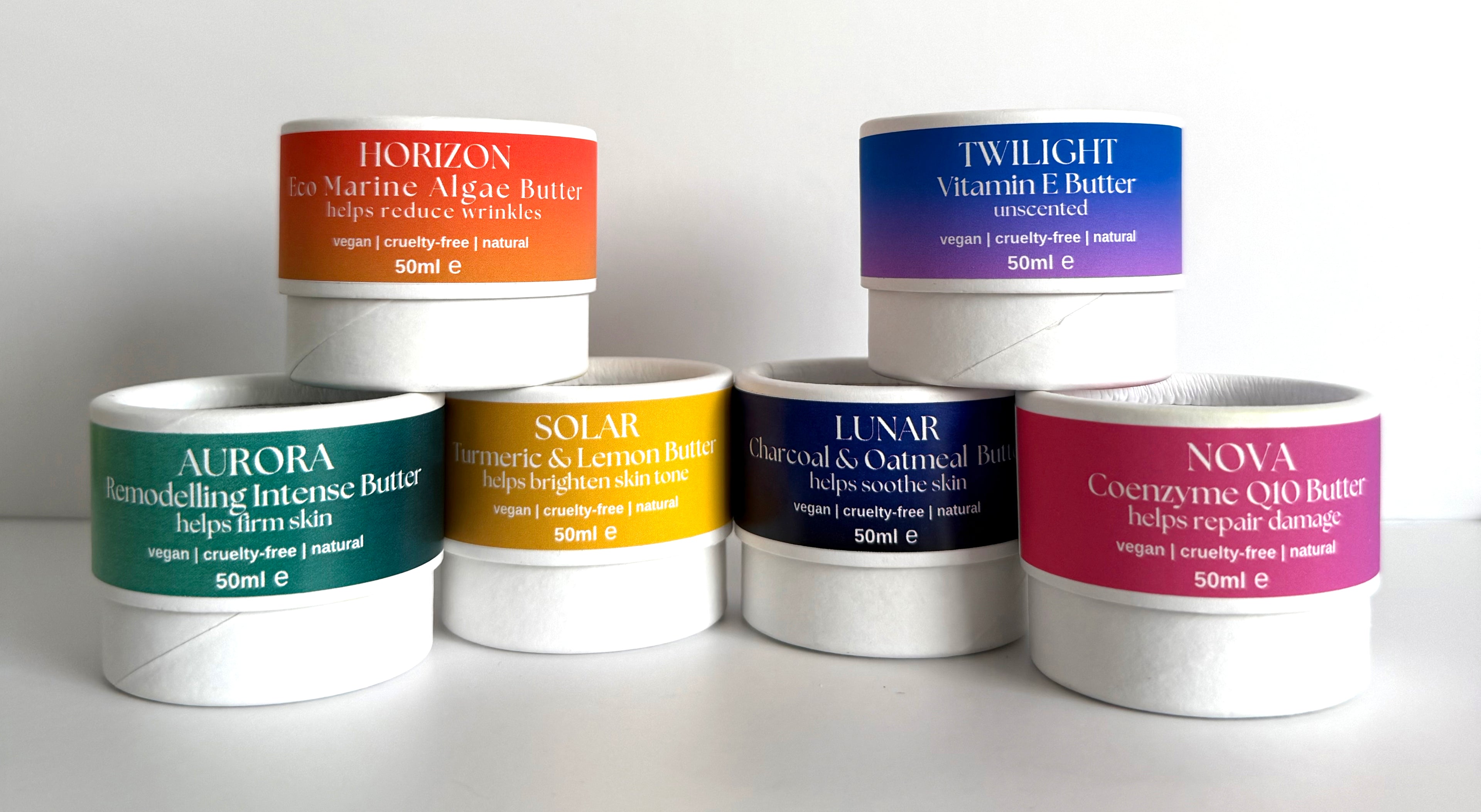 Set of cosmetic butters with colorful labels on a white background