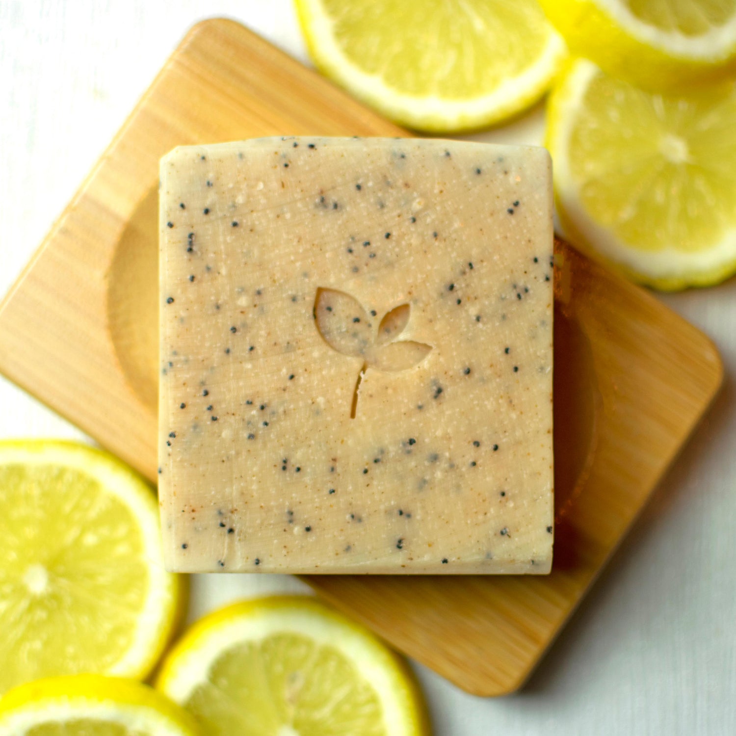 Citrus Crush handmade soap bar surrounded by citrus slices on a dish