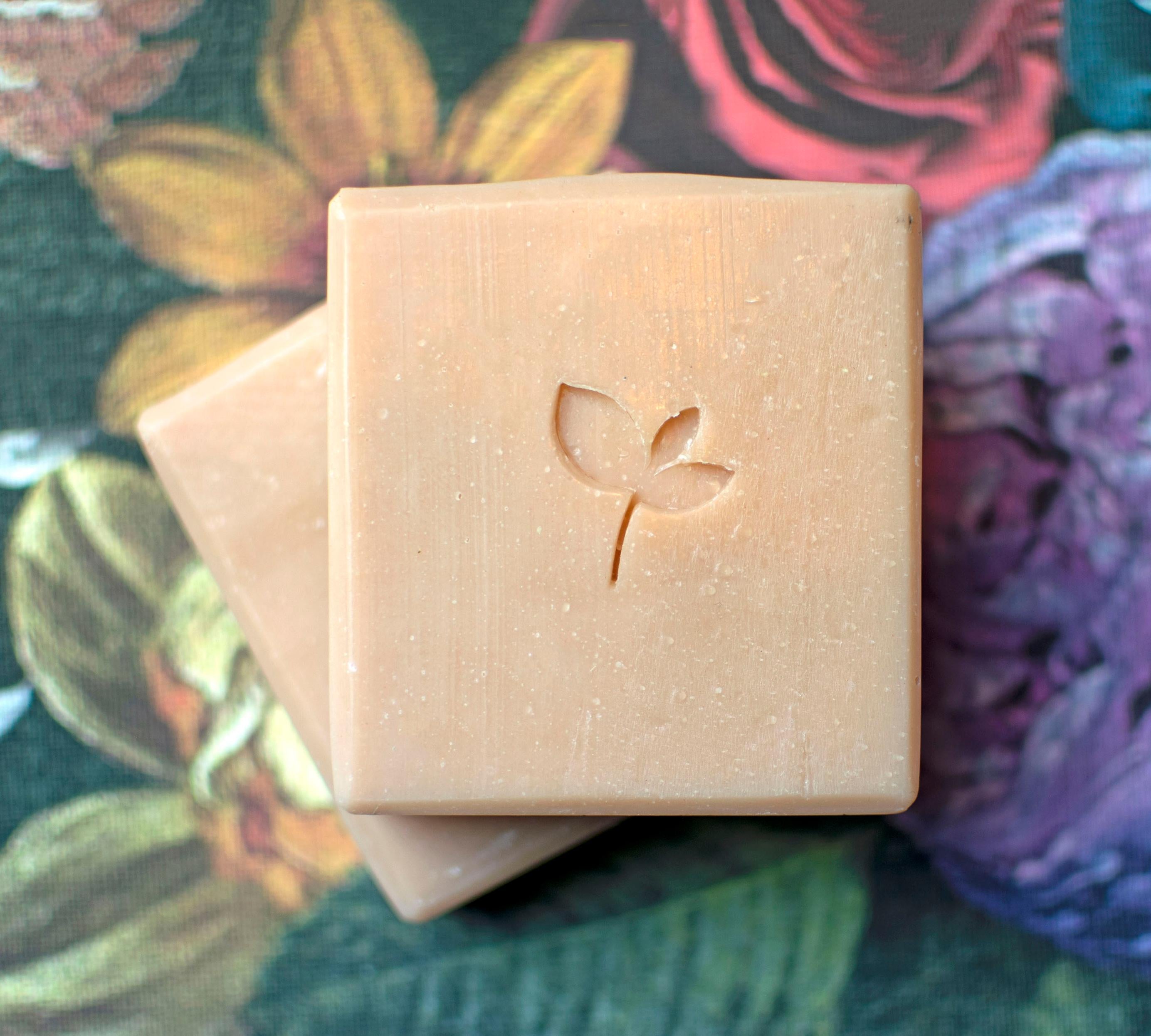 Enchanted Natural soap bars on a floral background