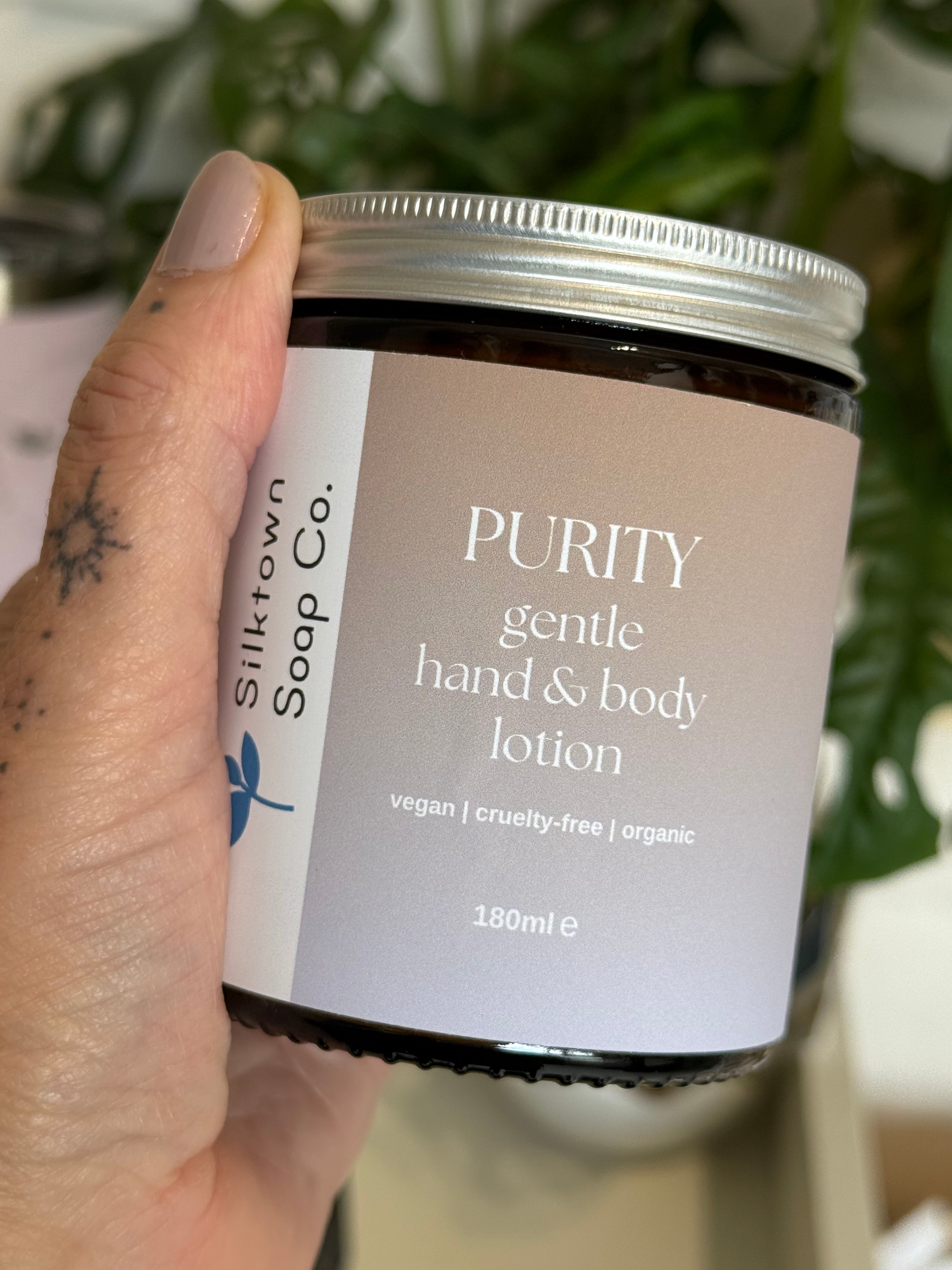 Hand holding a jar of &