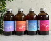 Collection of Silktown Soap Co. Botanical Skincare Oils including Dreamweaver, Sundazed, Moonstruck, and Spellcaster, all bottled in stylish amber containers.