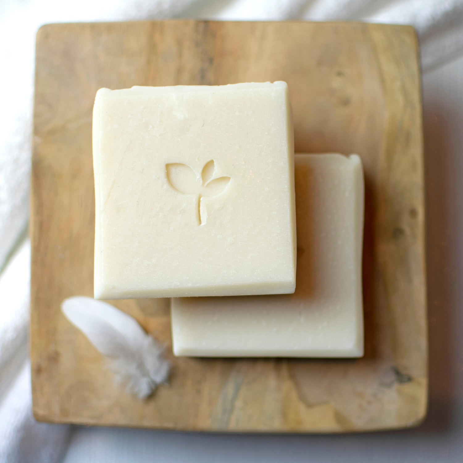 In the Buff natural soap bar with shea with wooden board and feather
