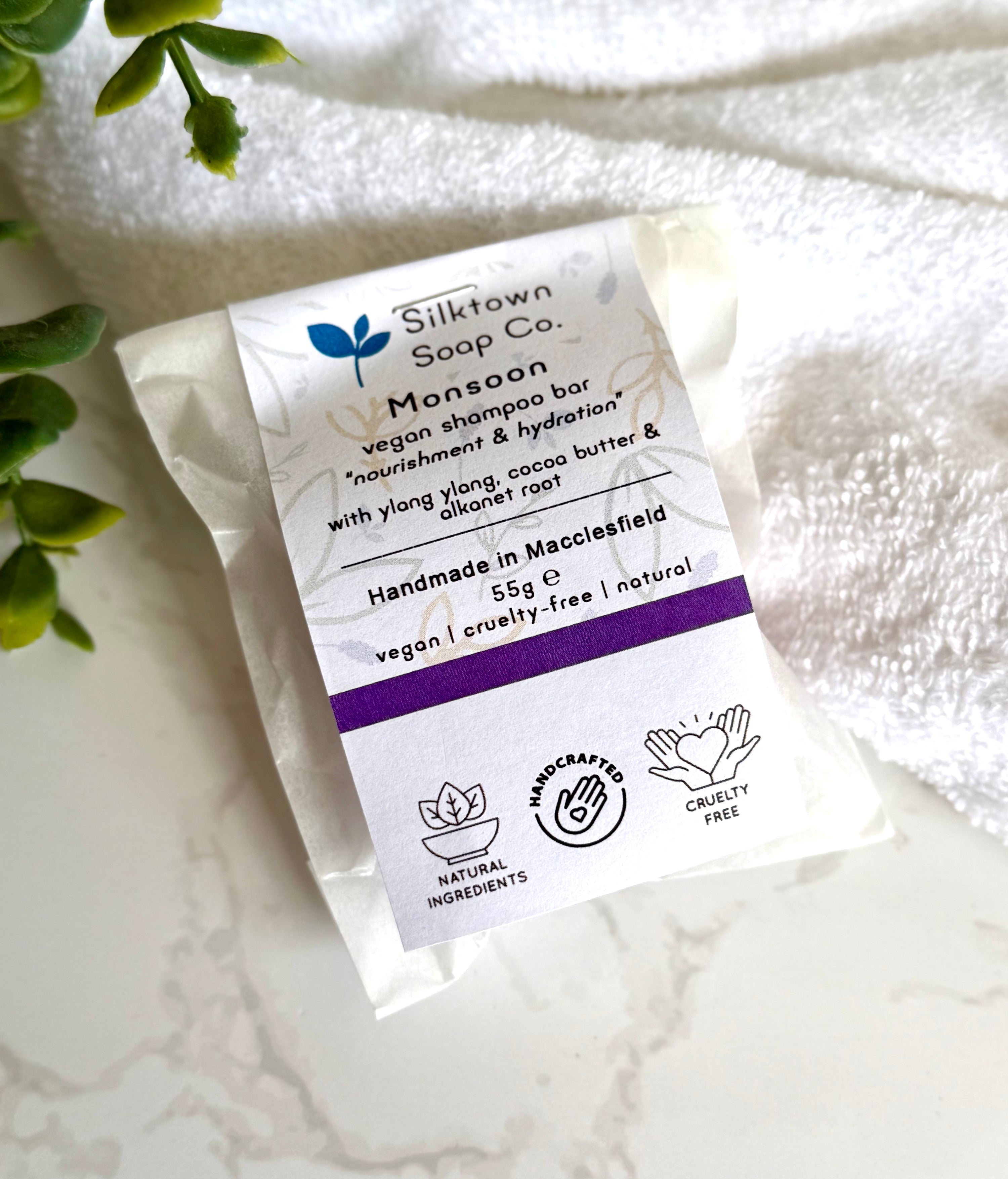 Silktown Soap Co. Natural Shampoo Bar - Monsoon packaging on a white towel with greenery.