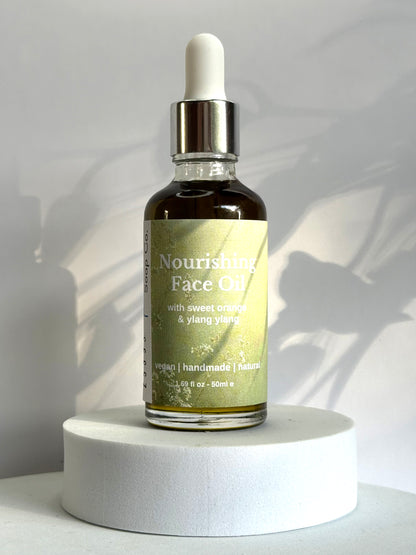 Bottle of Nourishing Face Tea on a white pedestal with a neutral background