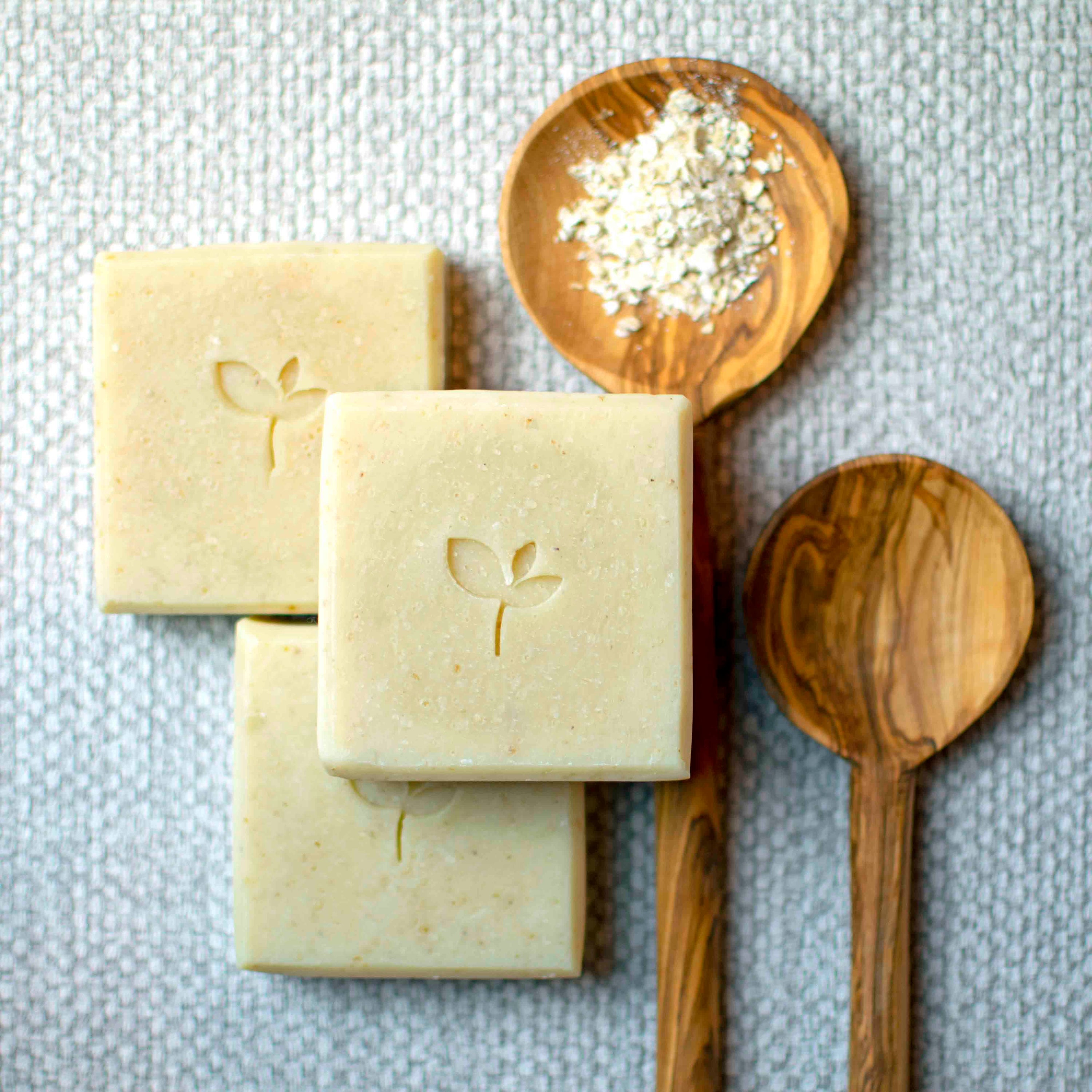 Oatmilk natural soap with spoons and oatmeal