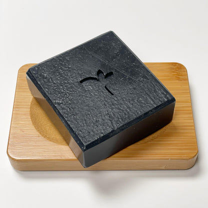 Practical Magic soap bar on a bamboo dish