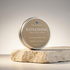 A round metal tin of Silktown Soap Co. Refreshing Shaving Soap sits on a rough light stone pedestal against a soft neutral gradient background.