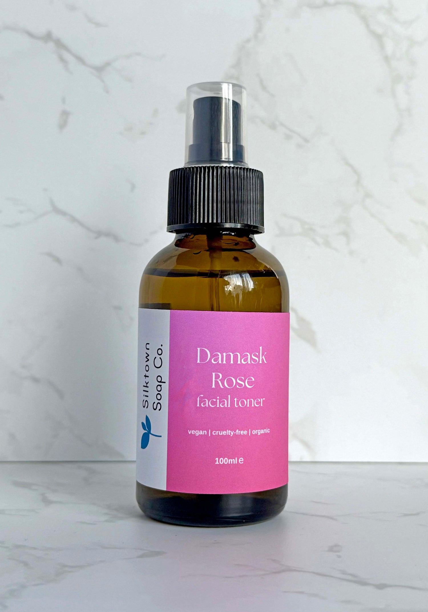 bottle of Natural Facial Toner with Bulgarian Damask Rose with a marble background