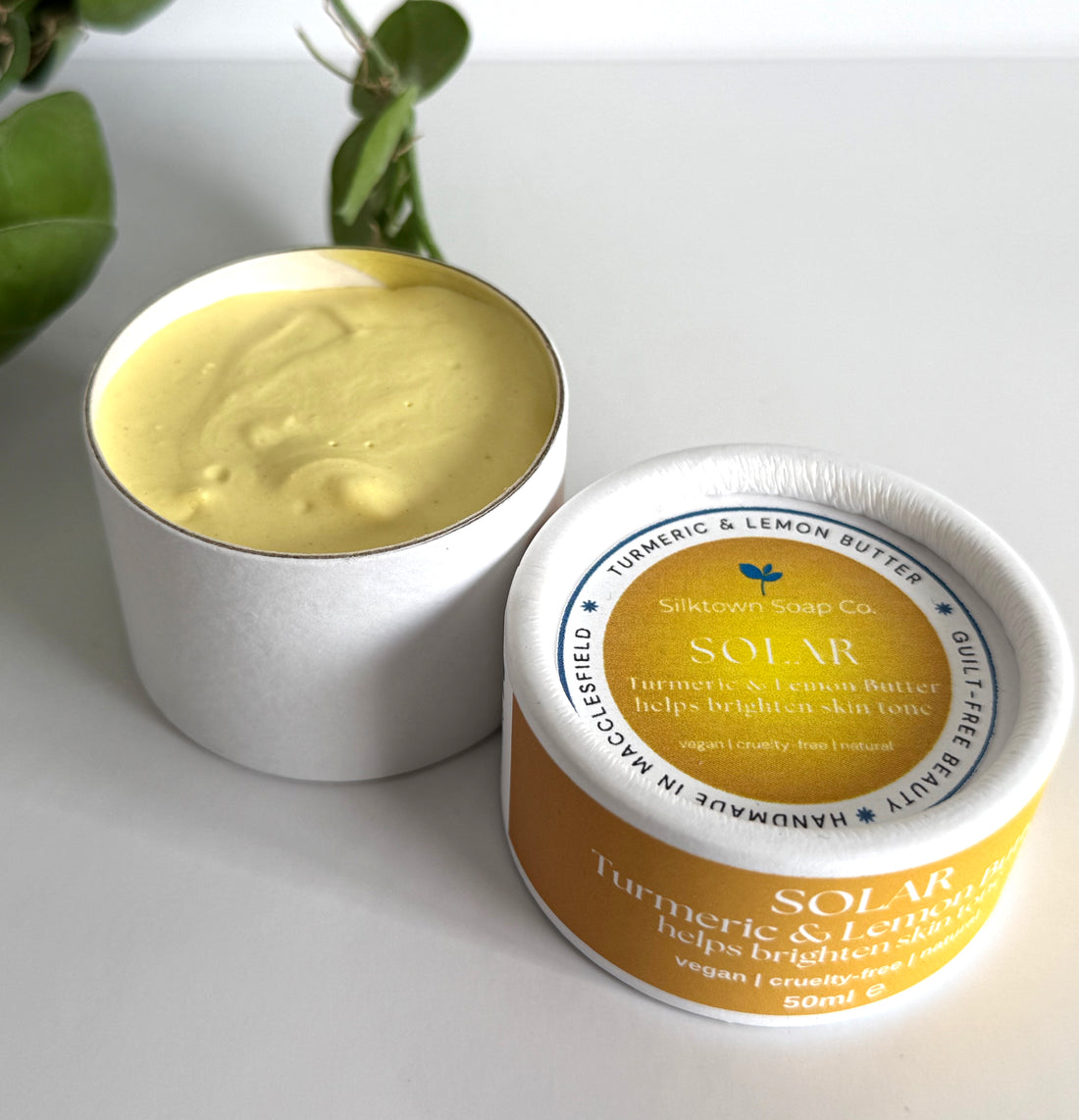 white container of cream with a lid showing &