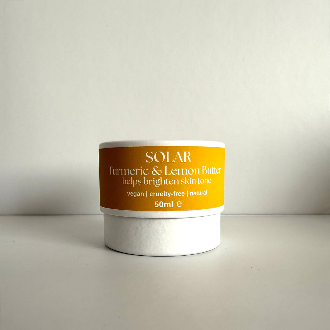 Jar of Solar Turmeric &amp; Lemon Butter on a light gray background