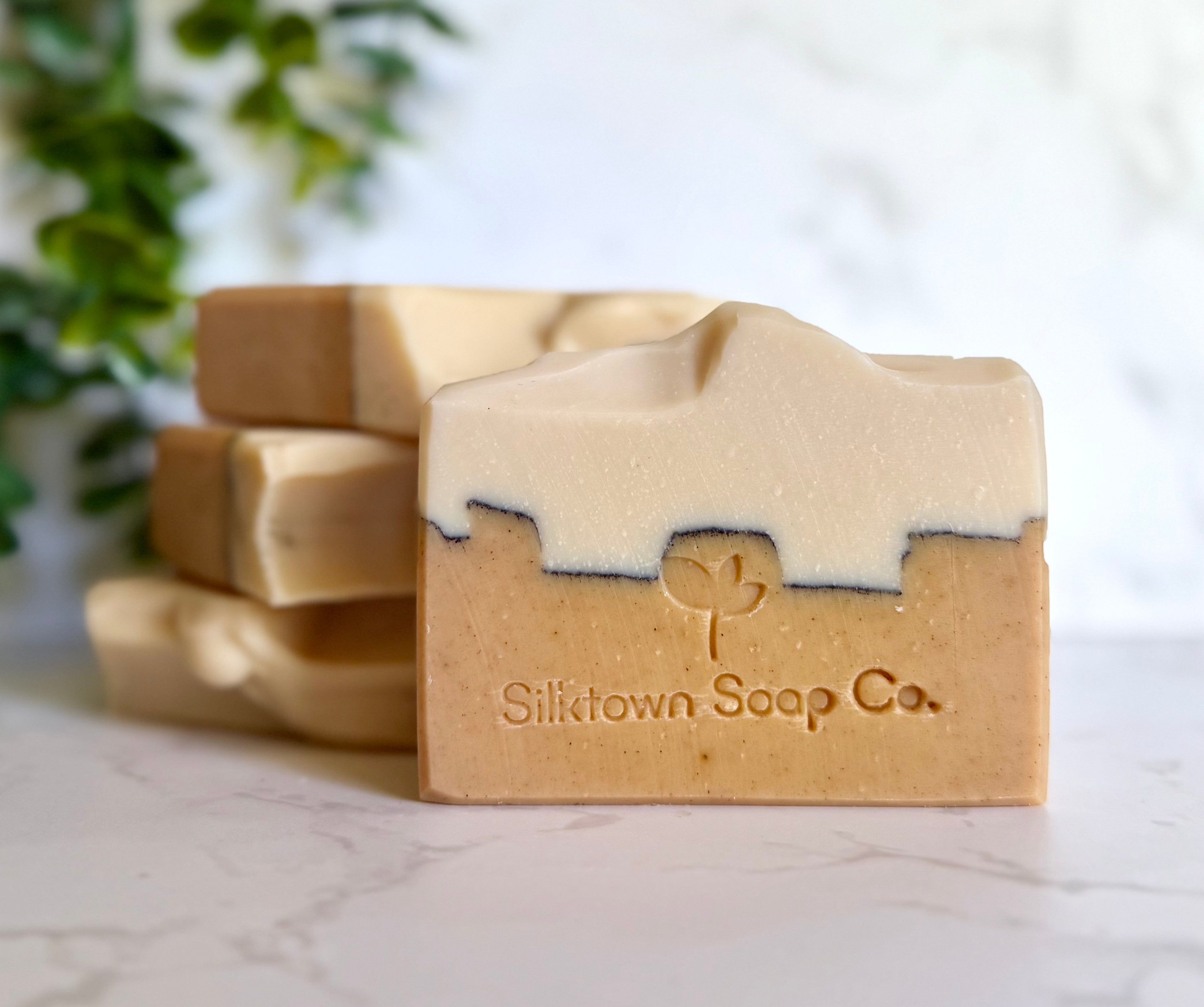Bar of soap with 'Silktown Soap Co.' branding on a marble surface with a blurred background