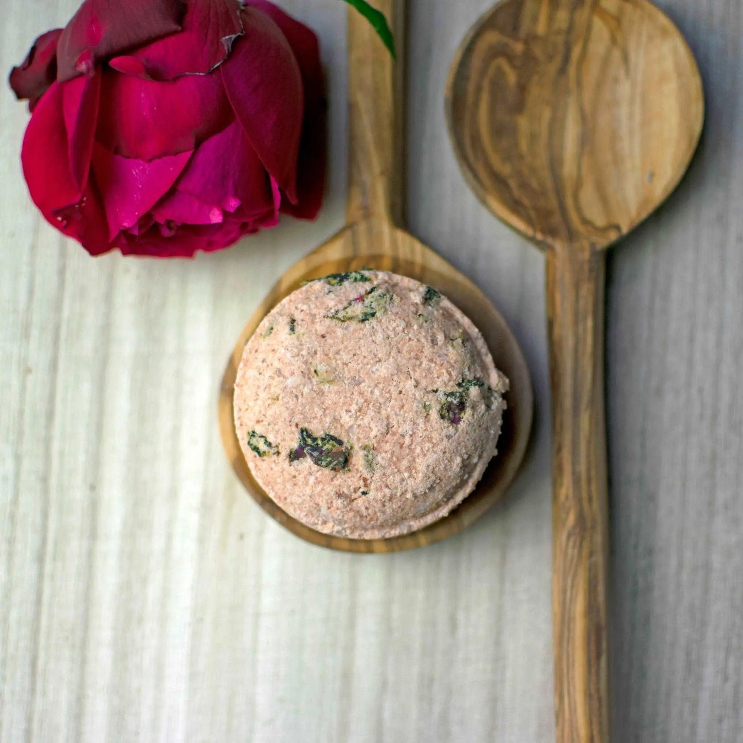 Amongst the Roses  - Natural vegan bath soak on a wooden spoon next to another spoon and rose petals