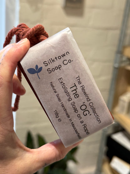 exfoliating natural soap on a rope held in the hand