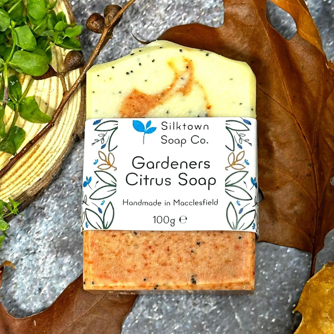 Gardeners Citrus Natural Soap with label amongst leaves and wood