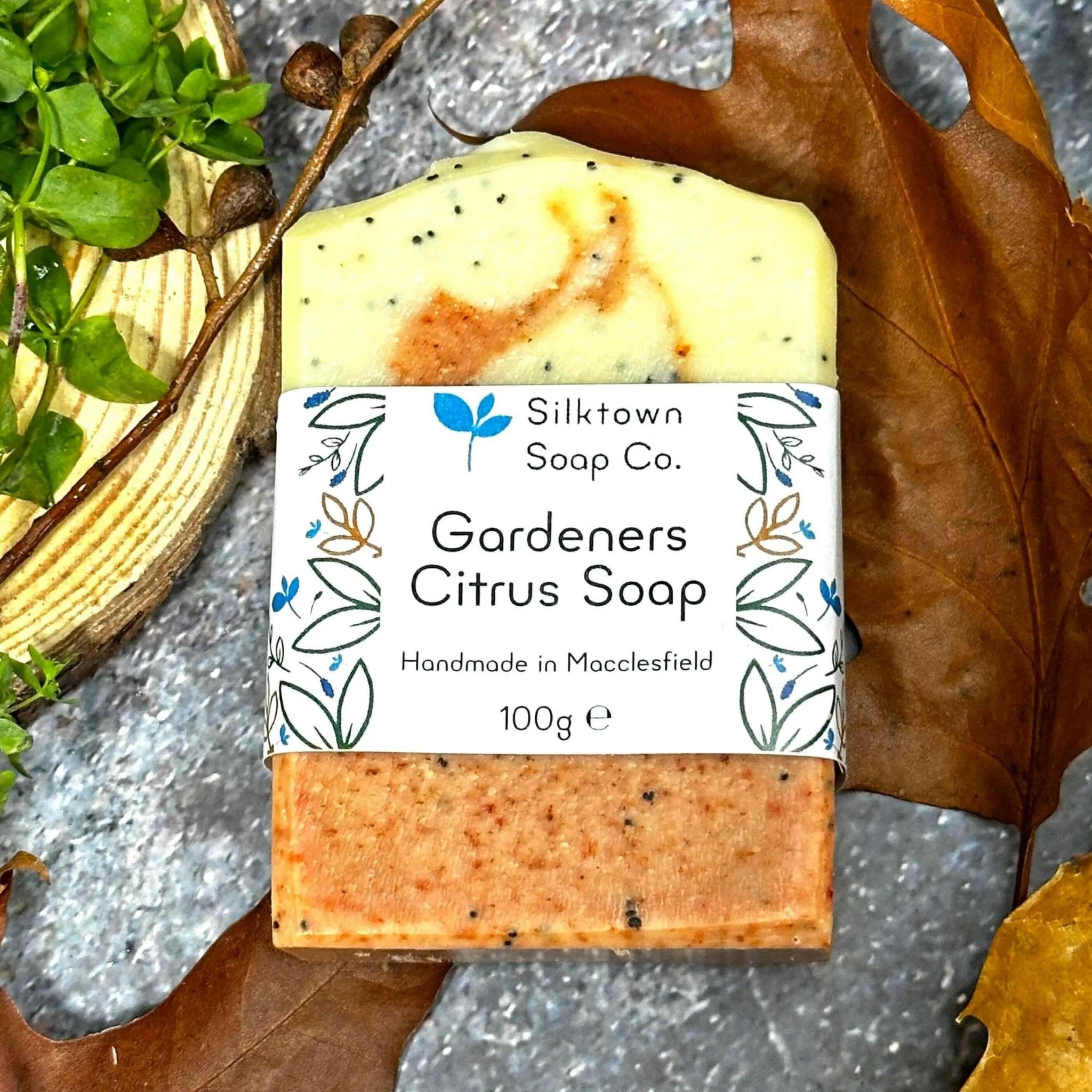 Gardeners Citrus Natural Soap with label amongst leaves and wood