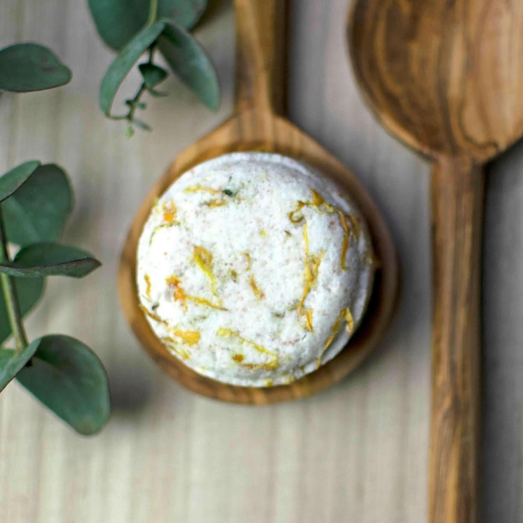 In the Orange Grove Natural Bath Bomb with wooden spoons and foliage
