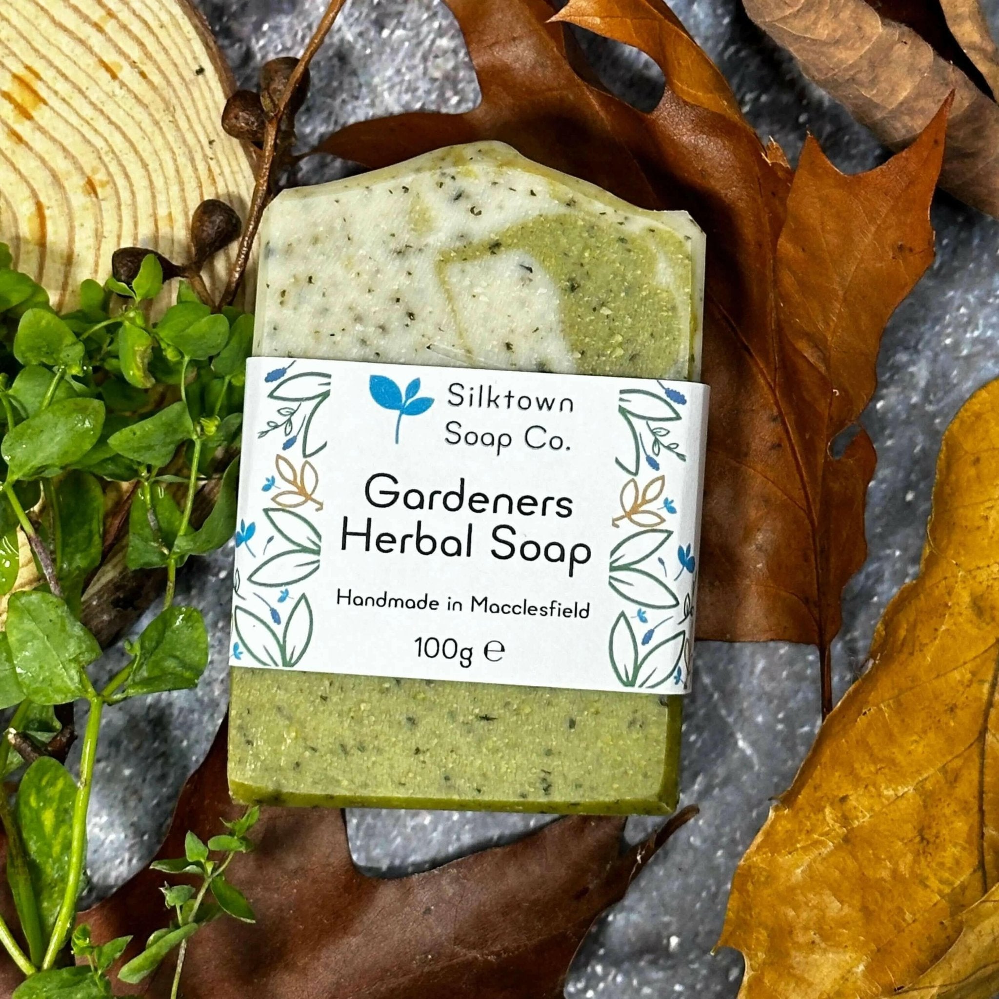 labelled Gardeners Herbal natural Soap bar on stone with leaves and wood