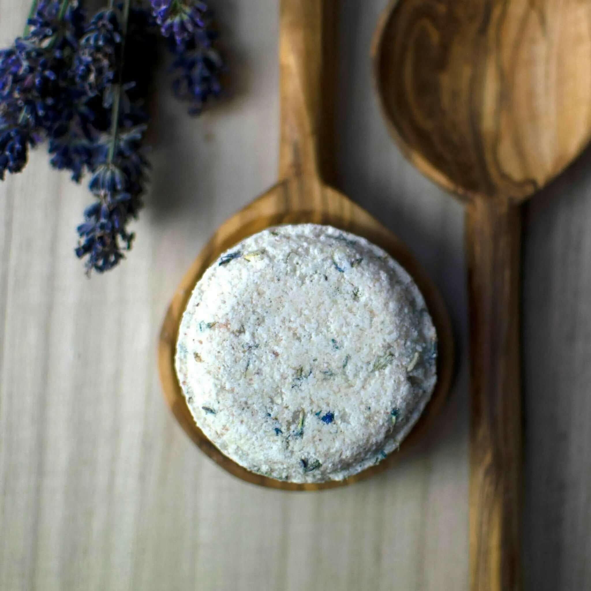Lavender Lullaby Natural Bath Bomb with wooden spoons and lavender sprig