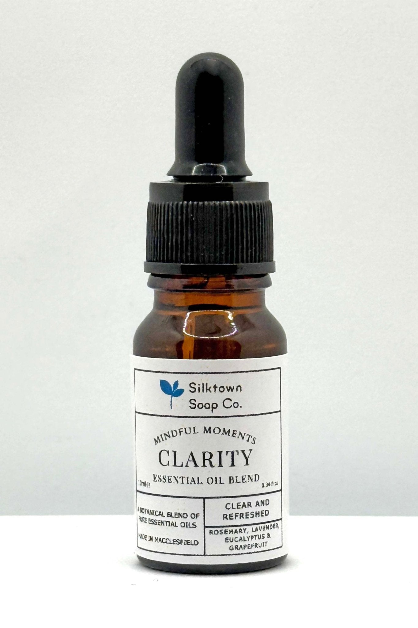 A small dark glass bottle with a dropper, labeled &