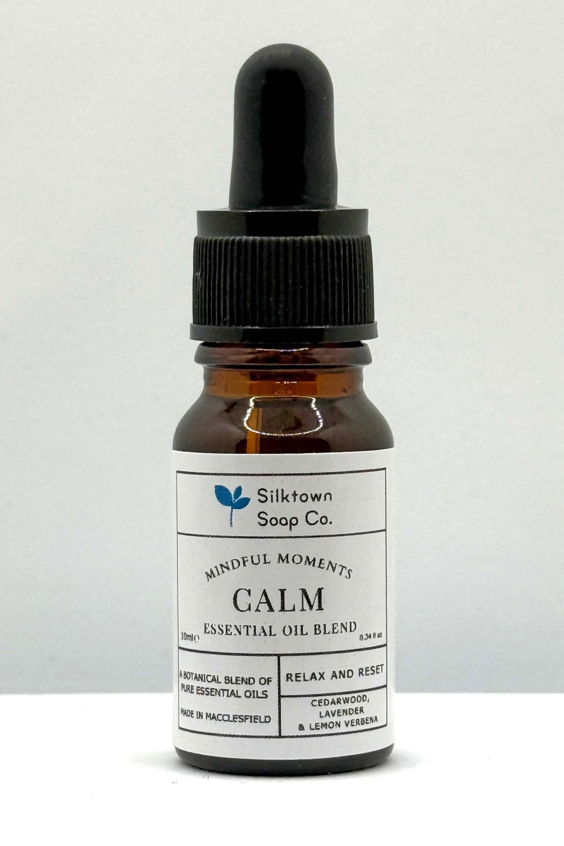 A small glass bottle with a dropper, labeled &