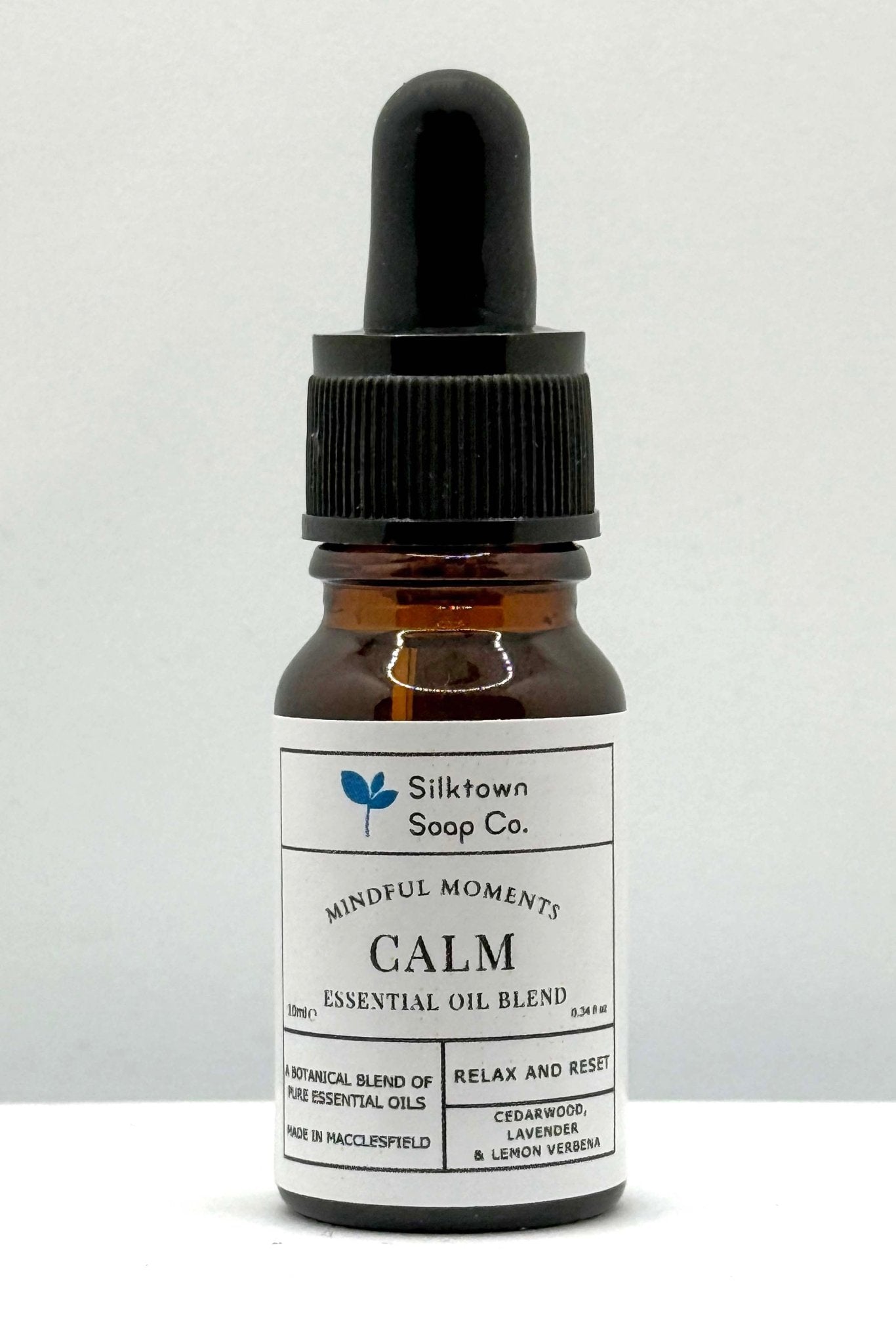 A small glass bottle with a dropper, labeled &