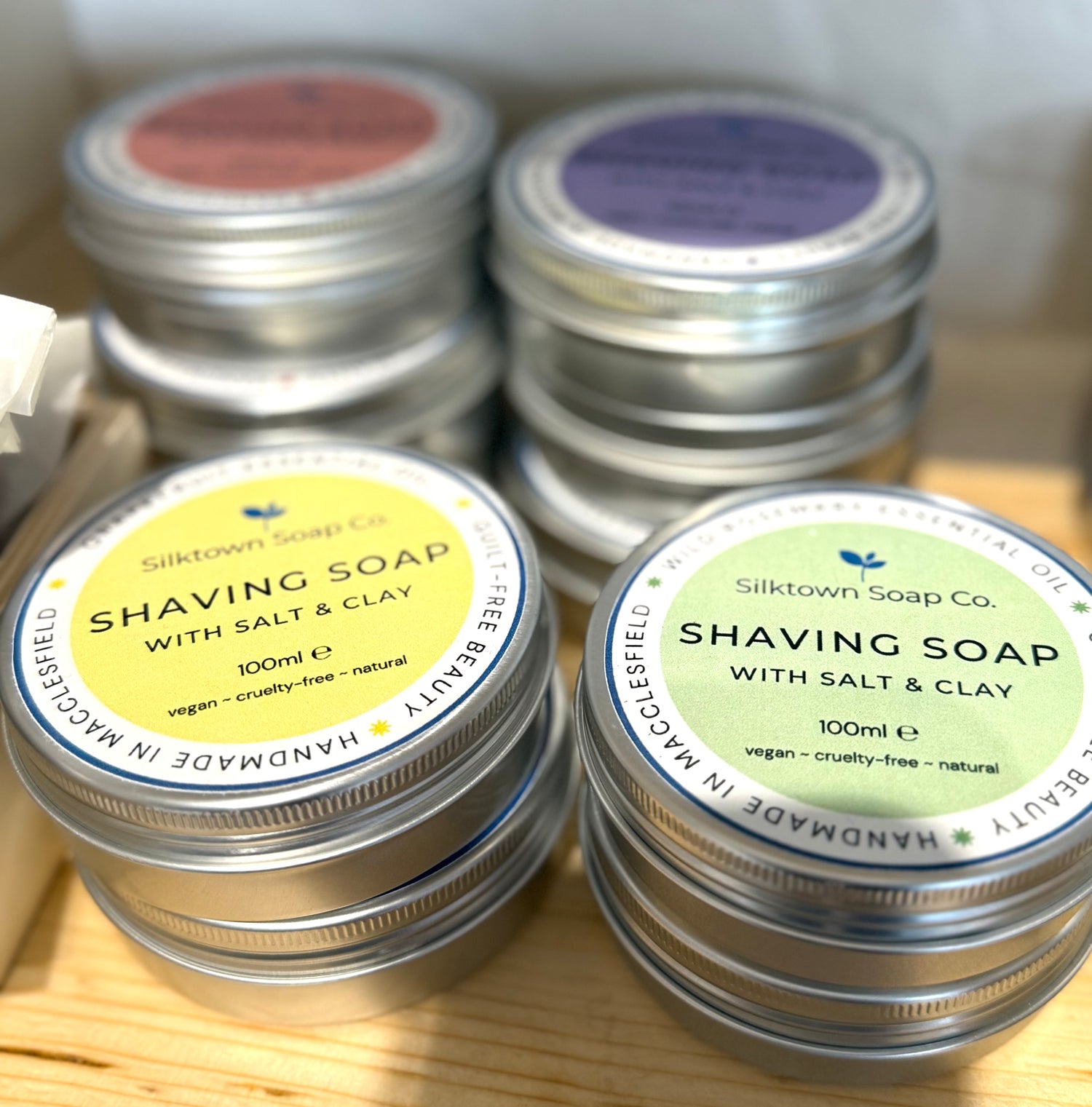 selection of Natural Soap for Shaving in tins on a shop shelf