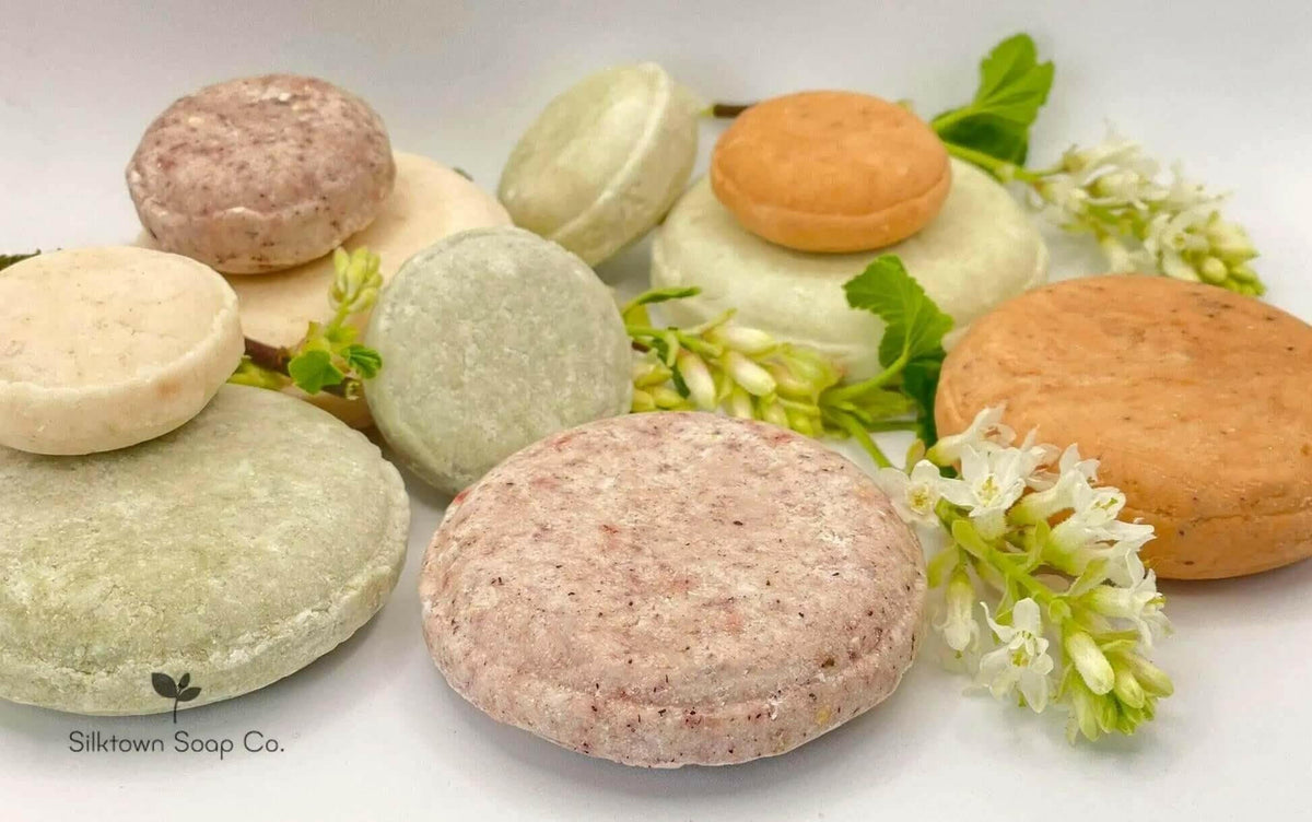 Natural solid shampoo Bars with a sprig of foliage and logo of Silktown Soap Company